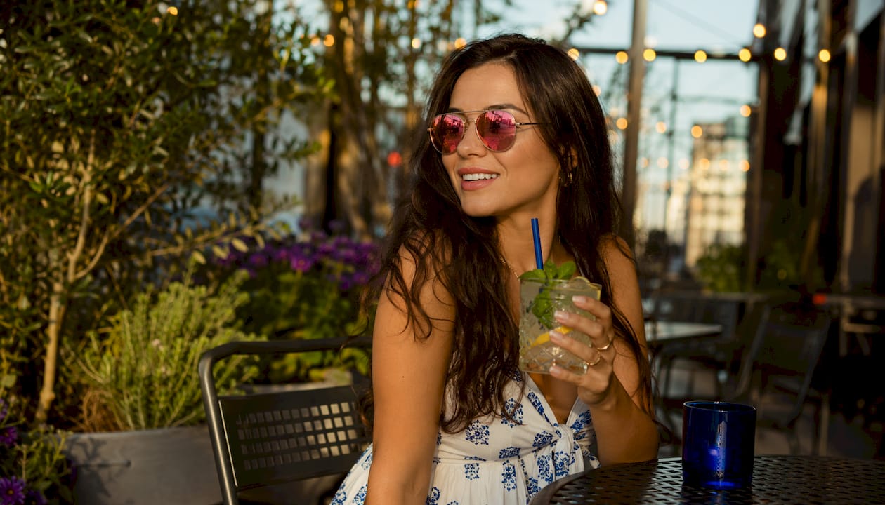 Woman wearing pink lens aviator sunglasses outdoor