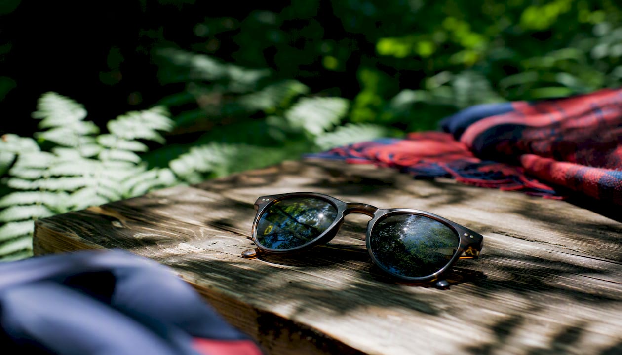 Mirrored sunglasses lenses reflecting light outdoors