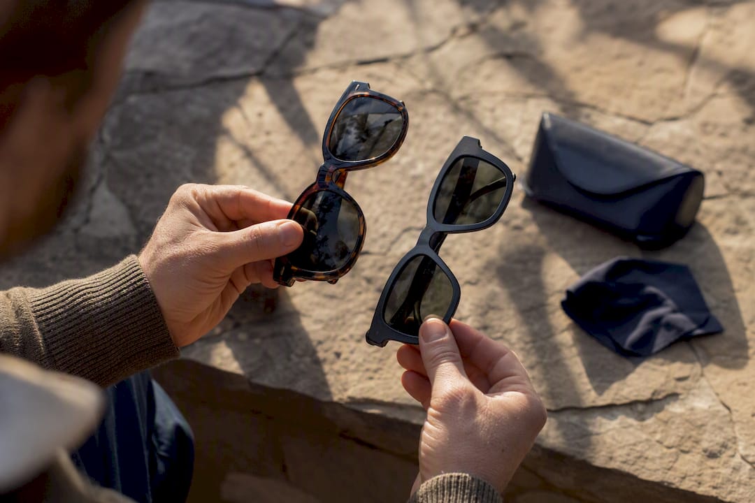 Hands holding acetate and nylon sunglasses frames