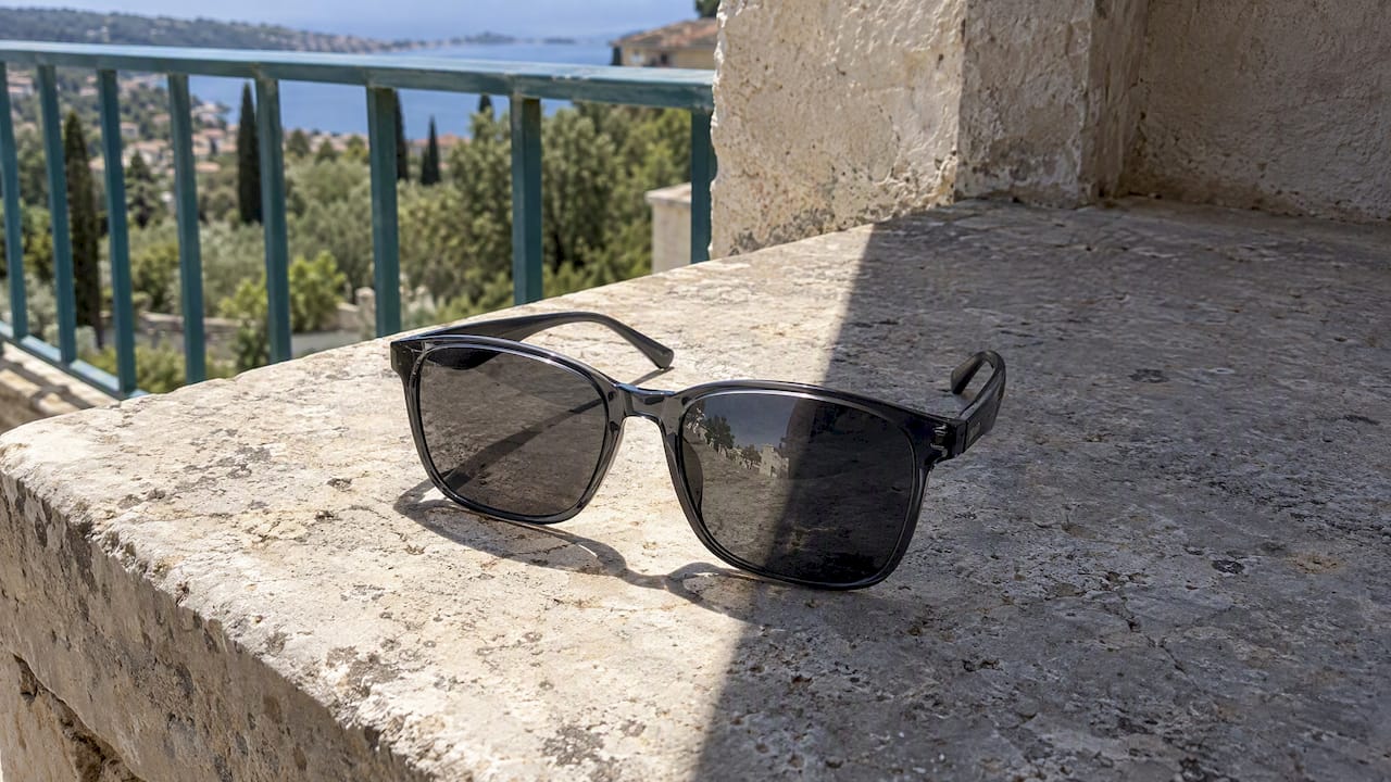 Sunglasses resting across a sunlit terrace