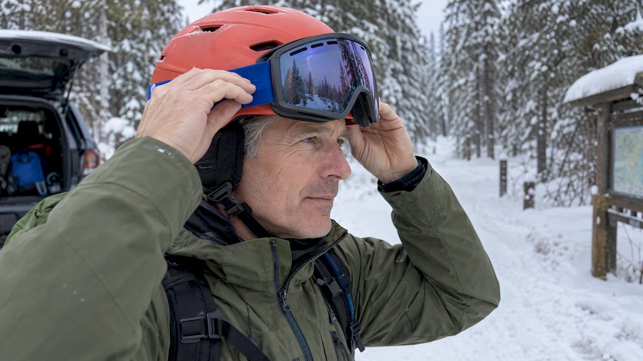 Snow goggles with visible vents at a trailhead